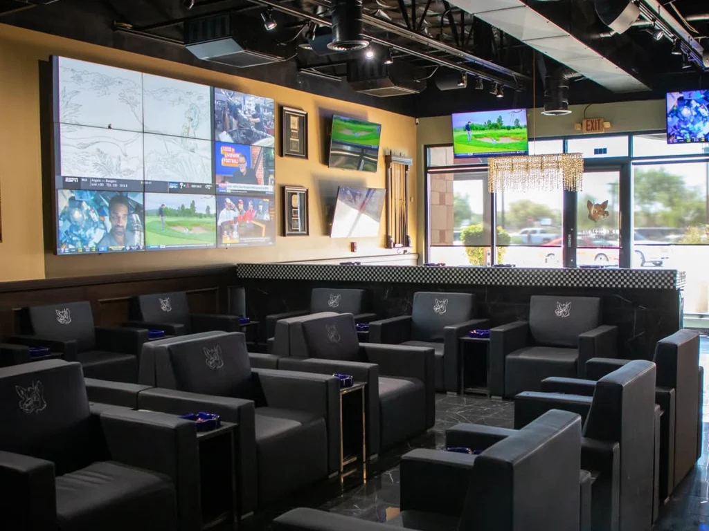 Fox Cigar Bar Gilbert lounge with fox-embossed leather armchairs facing a large video wall and TVs showing sports and golf