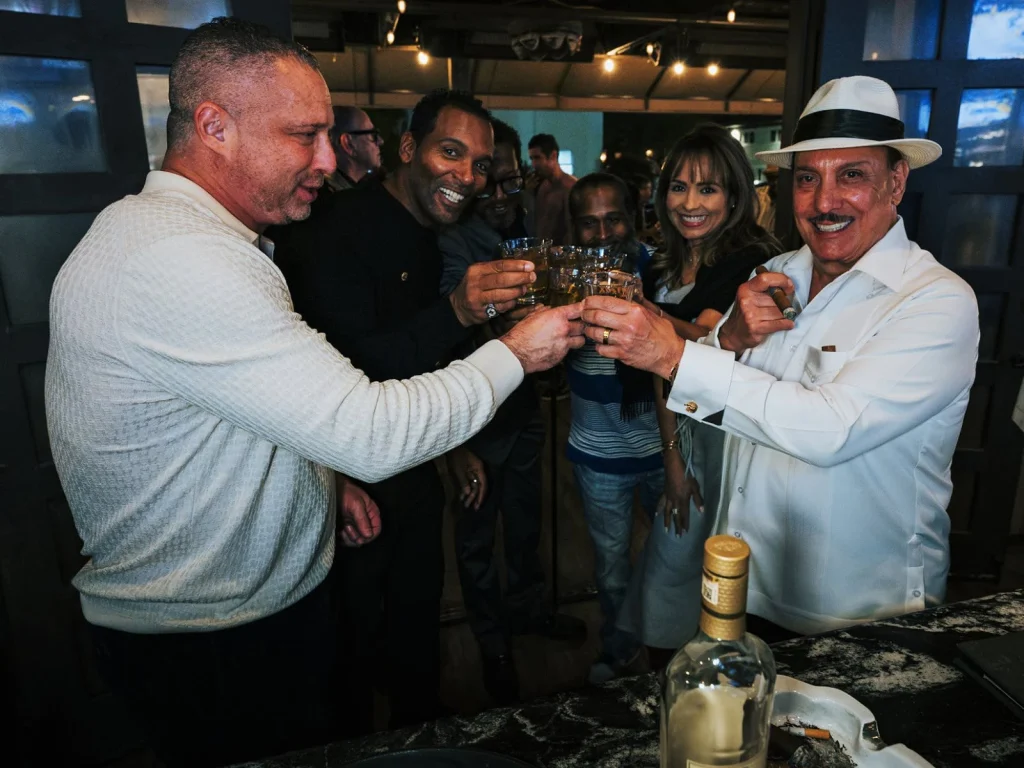 Guests raise their glasses with Carlito Fuente at the Fox Cigar Bar Scottsdale bar.