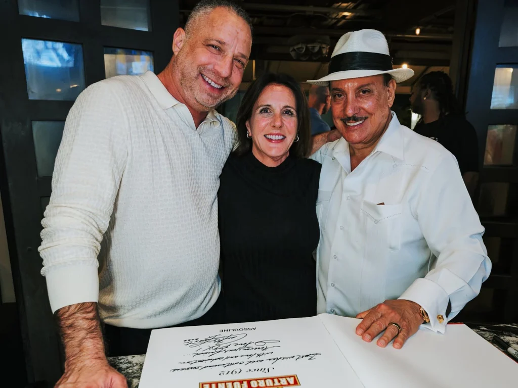 Carlito Fuente with guests and his personally inscribed Arturo Fuente Since 1912 book.