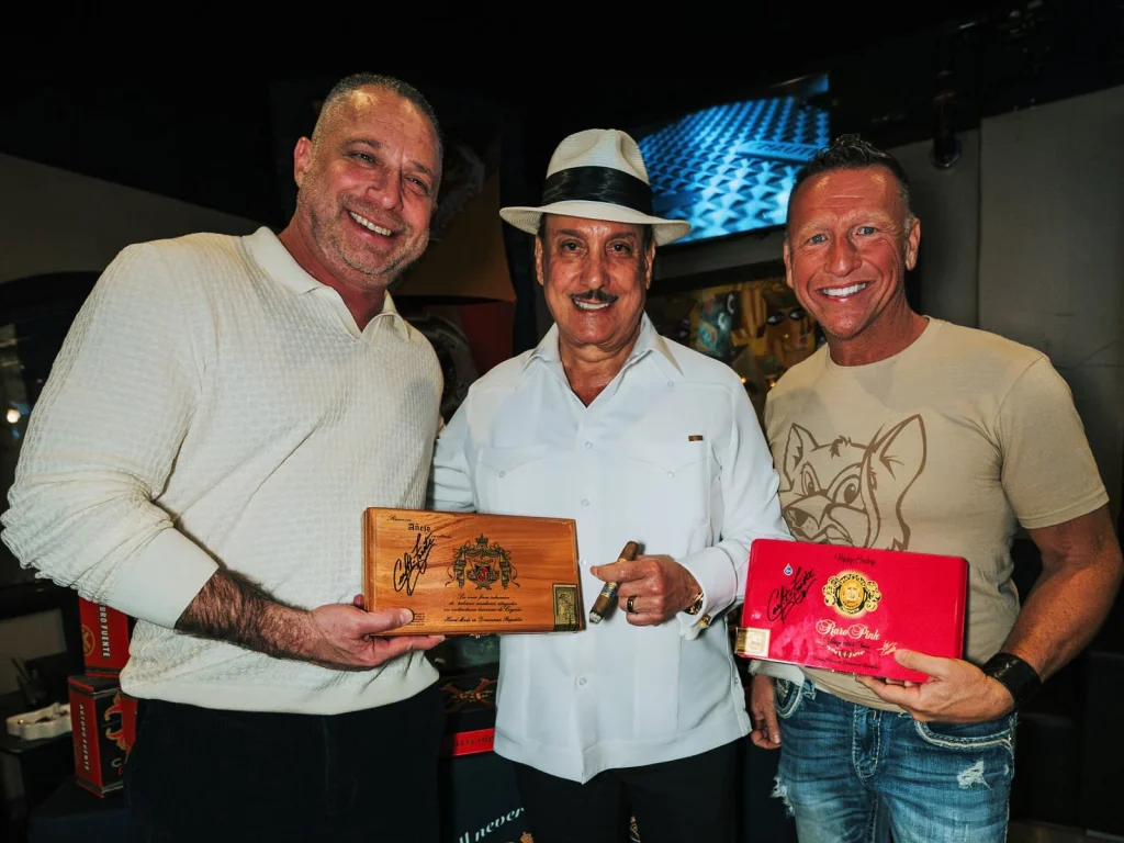 Guests show off their Arturo Fuente Añejo and Rare Pink boxes, freshly signed by Carlito Fuente.