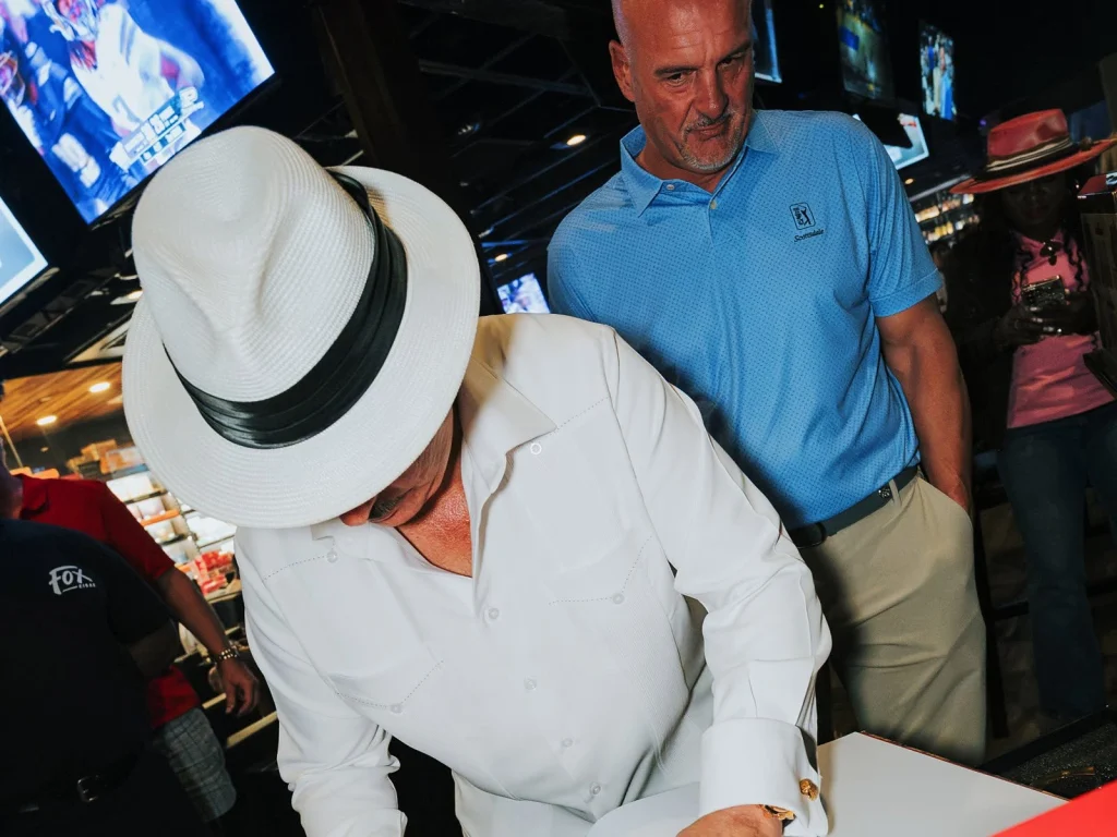 Carlito Fuente signs a guest's qualifying purchase during Fuente Friday at Fox Cigar Bar Scottsdale.