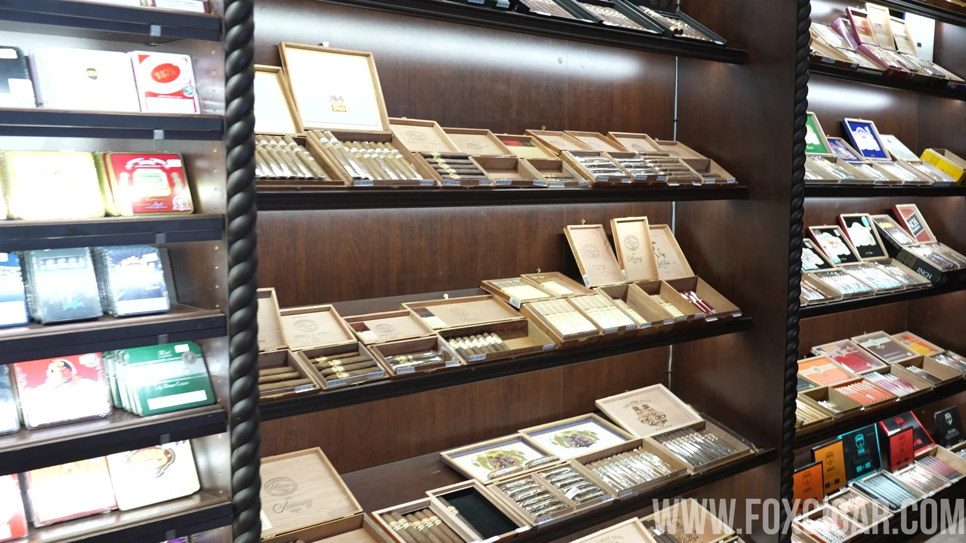 The humidor wall at Fox Cigar, lined with boxed cigars